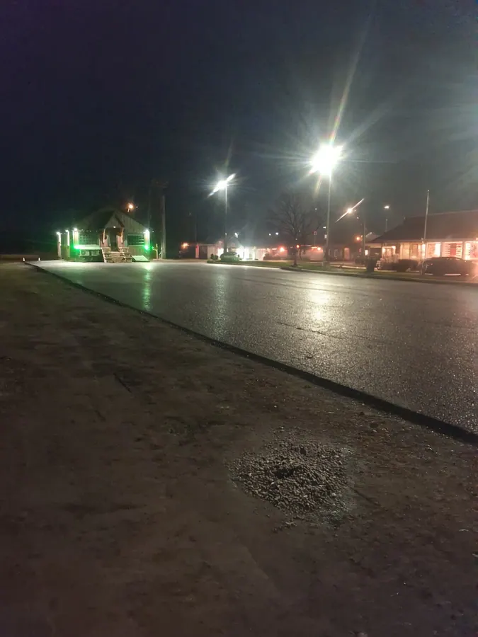 Fresh commercial asphalt paving completed at night